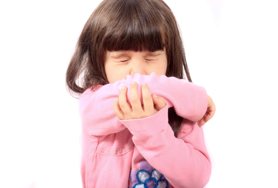 child coughing into elbow